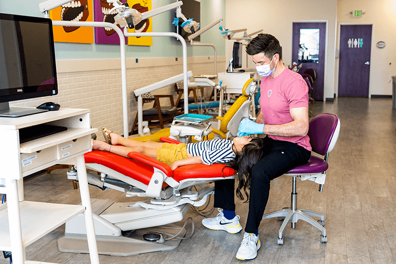 dr nate of Grin Pediatric Dentistry and Orthodontics working on patient in dental chair