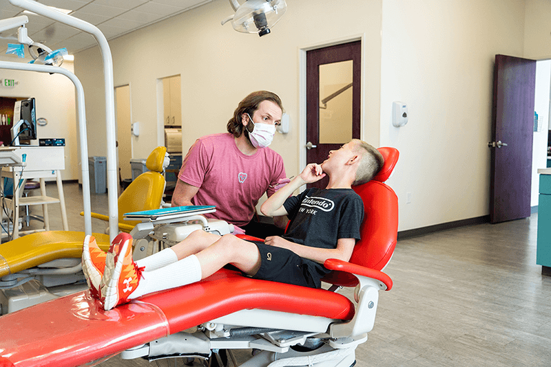 dr greg of Grin Pediatric Dentistry and Orthodontics with patient in dental chair