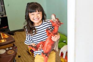 patient of Grin Pediatric Dentistry and Orthodontics holding dragon