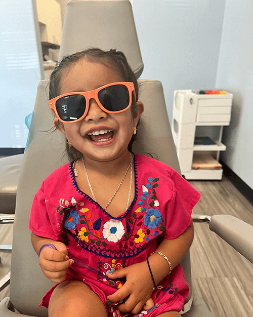 grin pediatric dentistry and orthodontics patient with sunglasses on